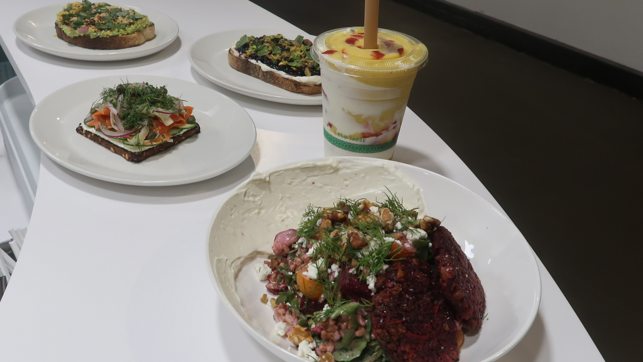 Photo of toasts and smoothies offered at Skyr. Pictured items include Millennial, Sweet and Simple, Scandinavian, and Turmeric Glow.